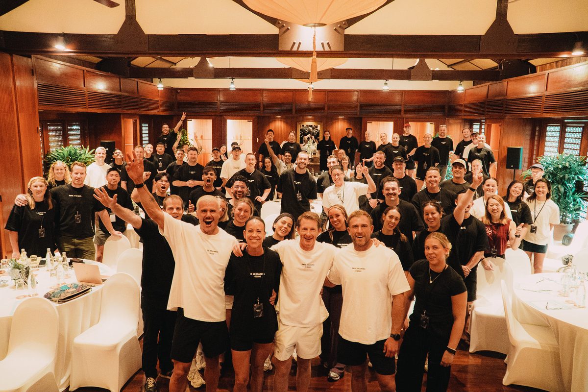 The whole REVL network in the conference room in Da Nang, arms in the air