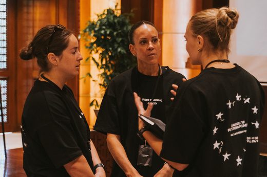 Three managers in conversation between sessions